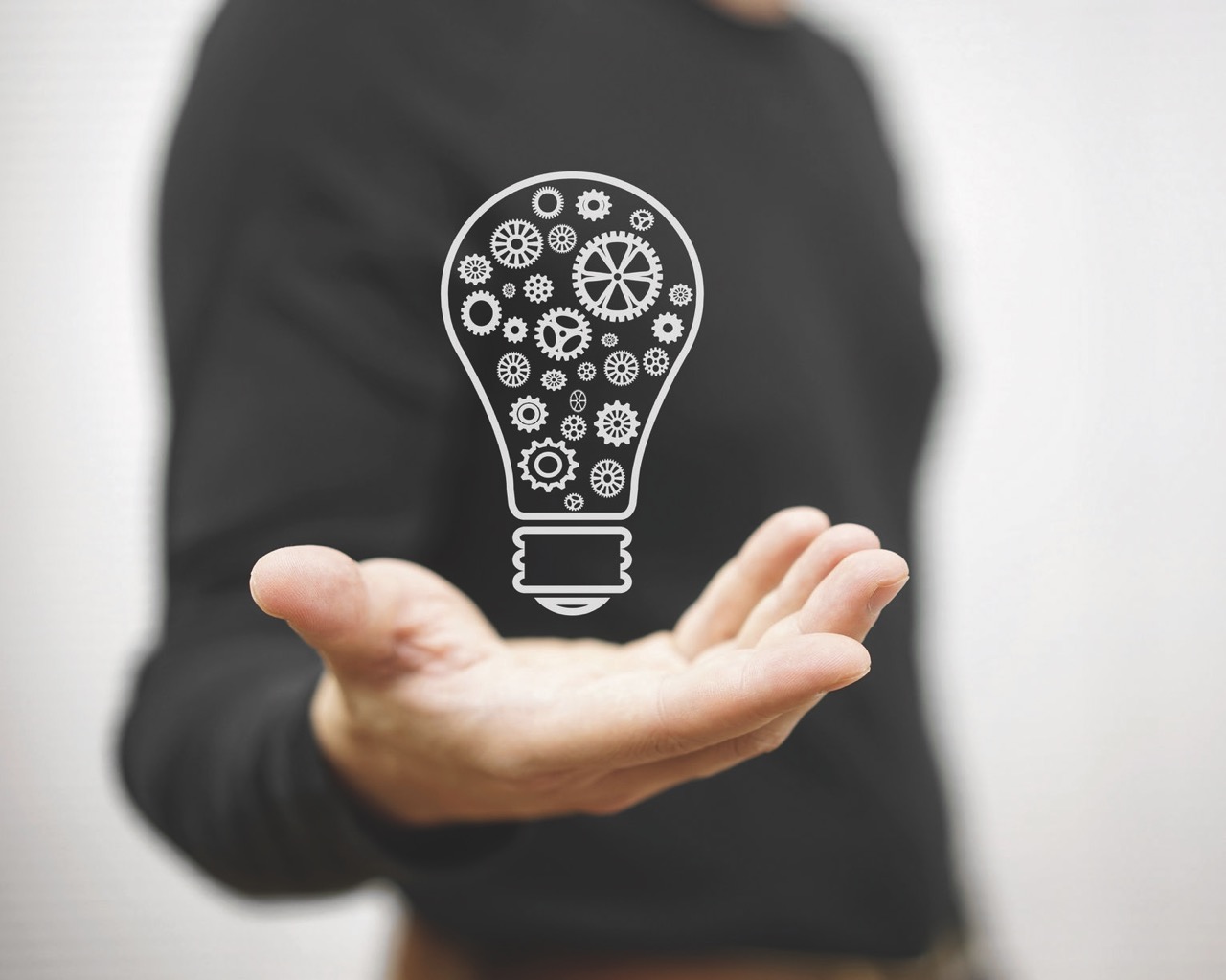 43133071 - man shows light bulb with gear inside